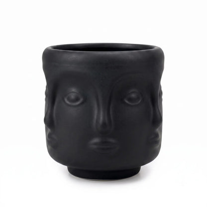 Wholesale matte black 3D sculptural face glass candle vessel 3.5 oz under spotlight