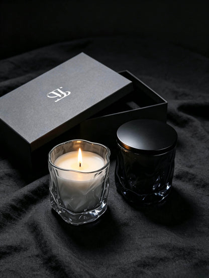 Lit smoky quartz wabi sabi candle jar styled with premium black box packaging for luxury home fragrance