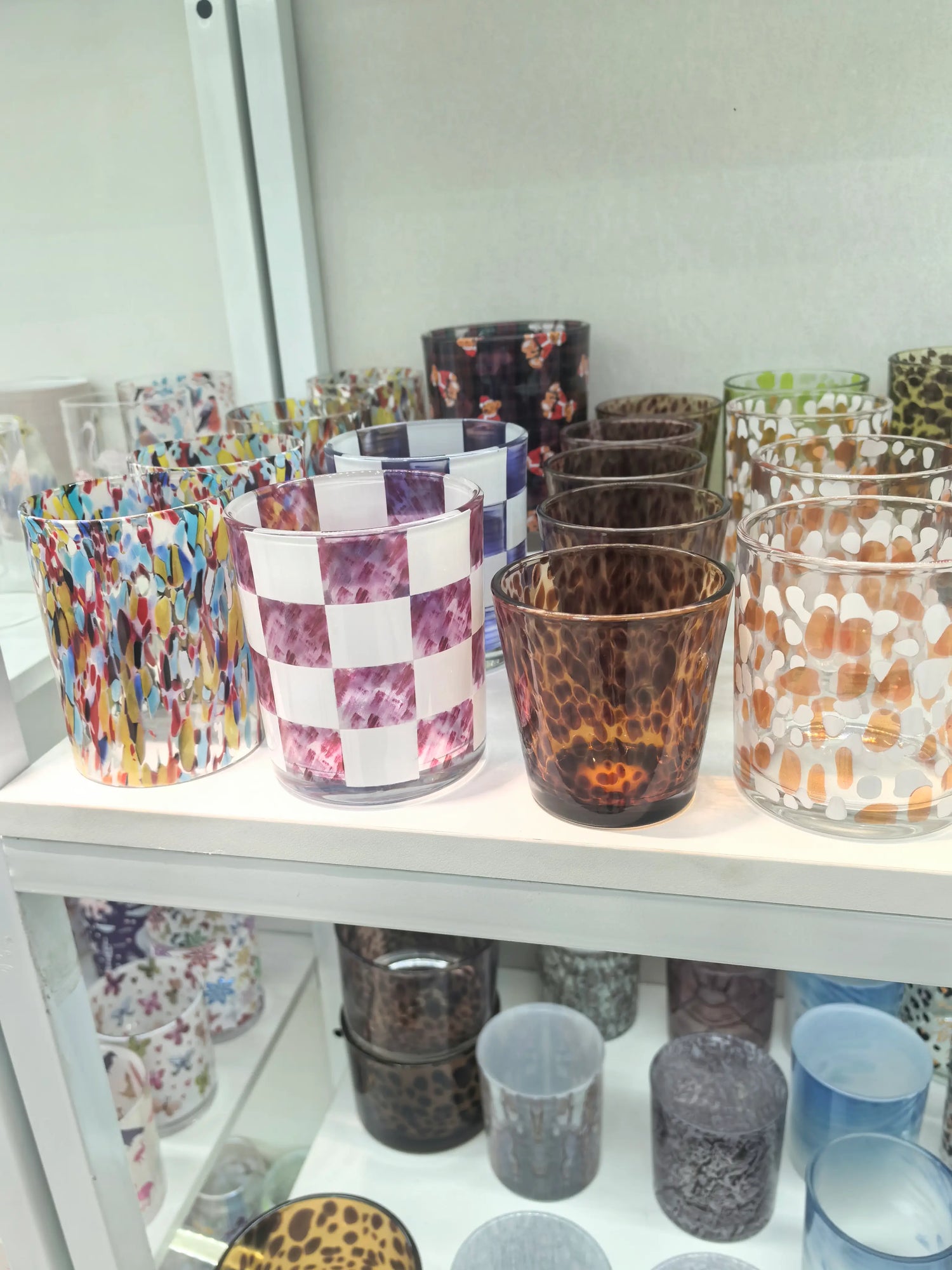 Decorative glass candle vessels showing a range of colors, finishes, and design directions for larger wholesale projects