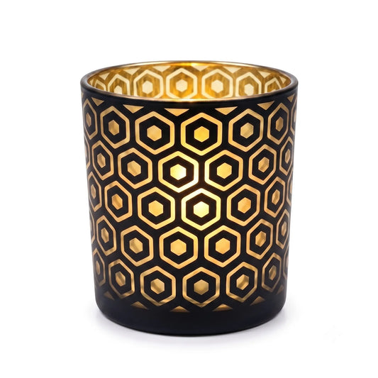 Wholesale matte black and gold hexagon cut out candle vessel 8 oz casting honeycomb light shadows under spotlight