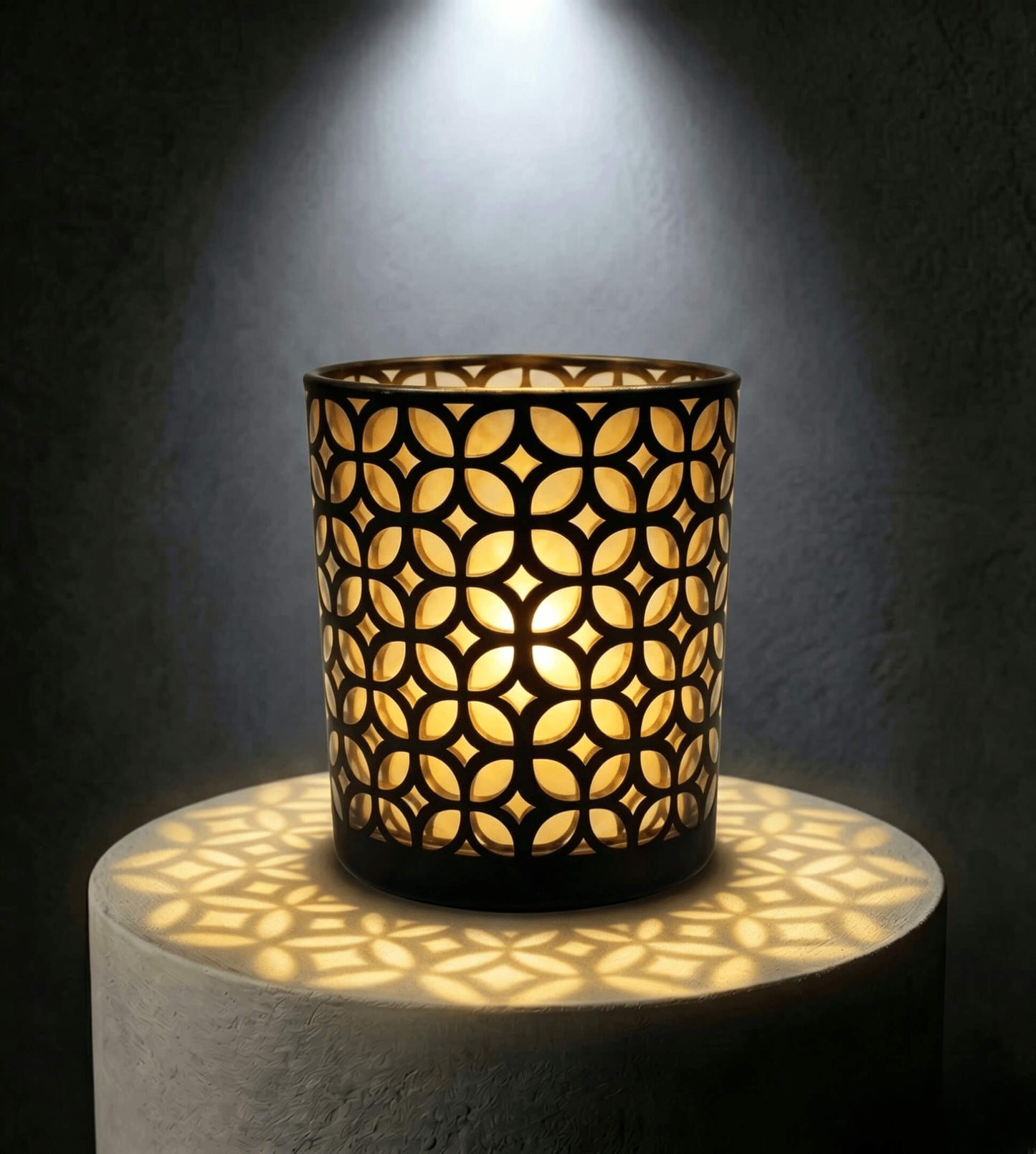 Wholesale matte black and gold interwoven cut out candle vessel 8 oz casting fluid geometric light shadows under spotlight
