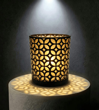 Wholesale matte black and gold interwoven cut out candle vessel 8 oz casting fluid geometric light shadows under spotlight