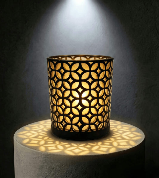 Wholesale matte black and gold interwoven cut out candle vessel 8 oz casting fluid geometric light shadows under spotlight