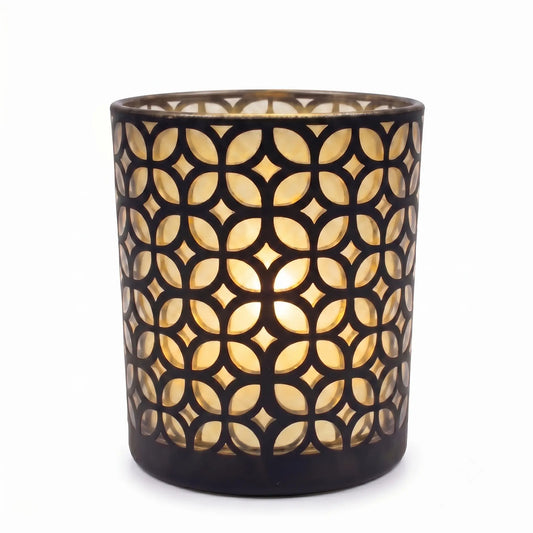 Wholesale matte black and gold interwoven cut out candle vessel 8 oz casting fluid geometric light shadows under spotlight