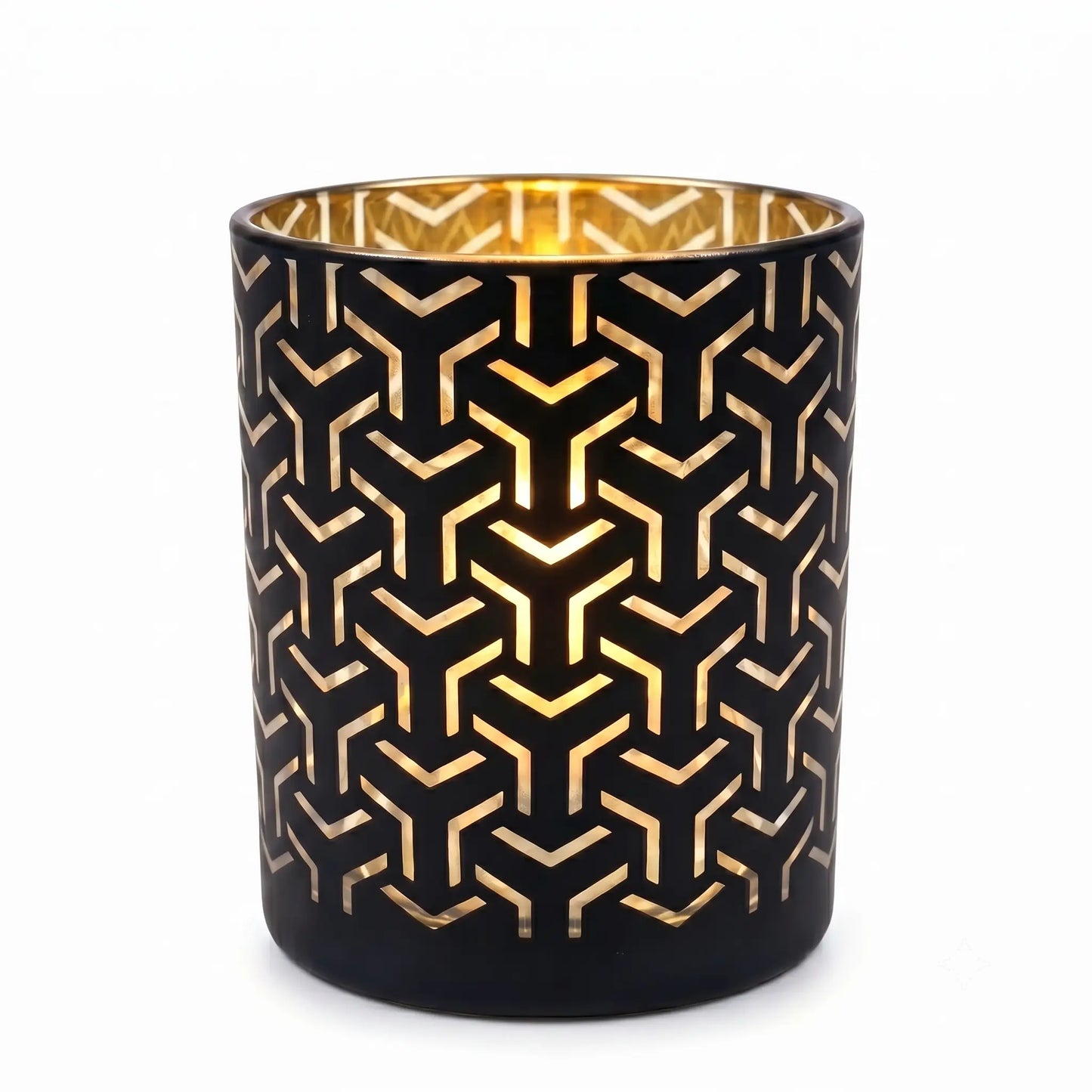 Wholesale matte black and gold labyrinth cut out candle vessel 8 oz casting intricate geometric shadows under spotlight